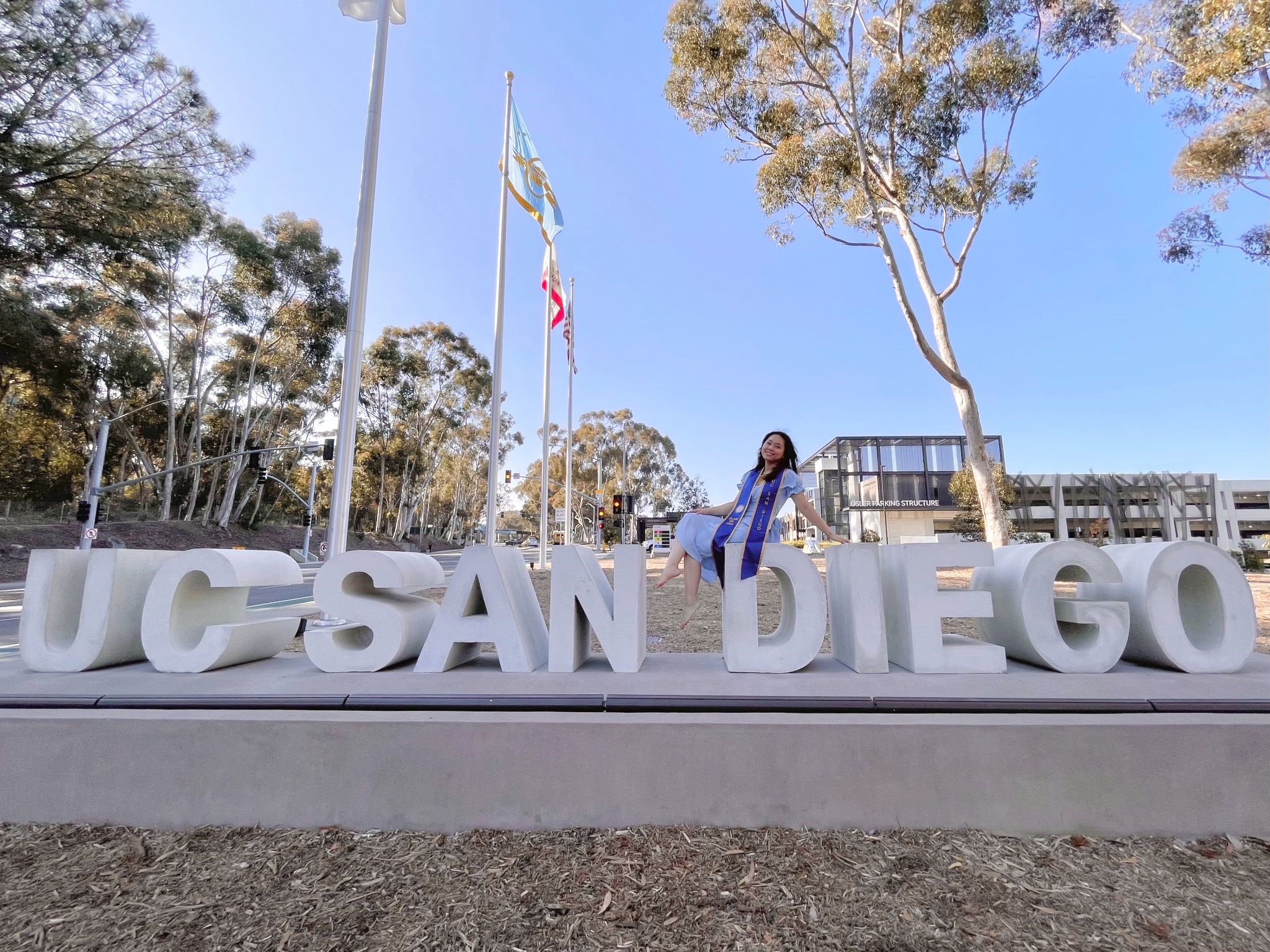 Person in front of UCSD sign