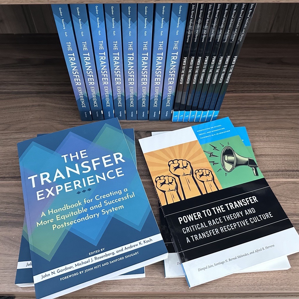 an image of a books Titled the Transfer Experience and  power to the transfer stacked in a bookshelf 